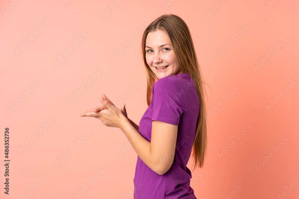 Teenager Ukrainian girl isolated on pink background applauding Teenager Ukrainian girl isolated on pink background applauding