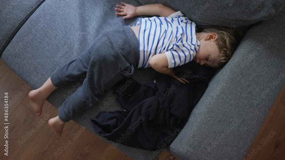 Child napping on couch in the afternoon Child napping on couch in the afternoon