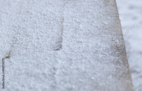 Closeup shot of snow on wooden planks texture