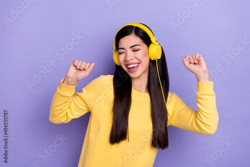 Photo of young cheerful girl enjoy sound clubber mp3 chill free-time isolated over purple color background