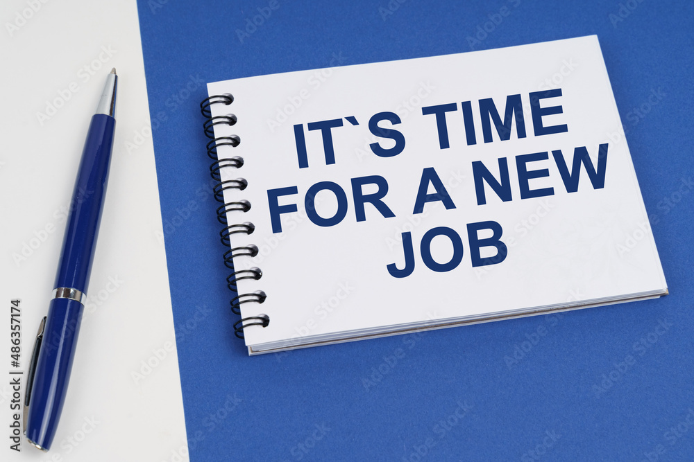 On a blue-white surface lies a pen and a notebook with the inscription - It is Time For A New Job On a blue-white surface lies a pen and a notebook with the inscription - It is Time For A New Job