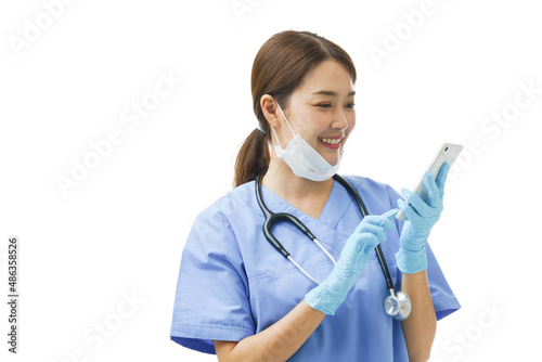 Young Asian woman doctor nurse wearing a surgical mask on her chin smiling at mobile phone consulting giving instruction and diagnose the patient health problem though online chat healthcare service. photo