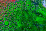 Bubbles in oil in water on green colour abstract background