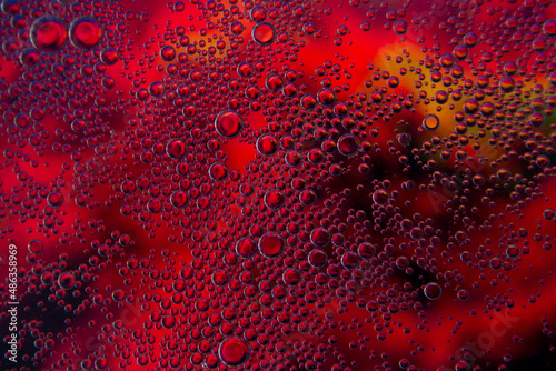Bubbles in oil in water on pink  black and yellow colour abstract background