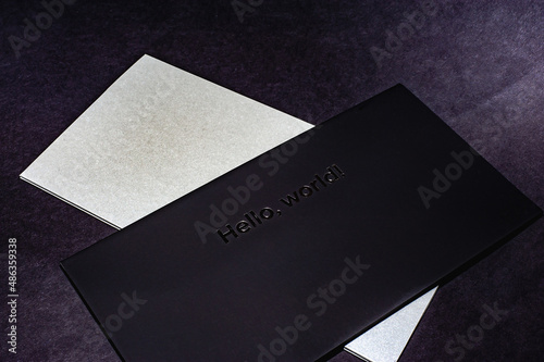 Black envelope on a black flat background, luxury corporate identity and corporate identity design for layouts with the inscription hello world