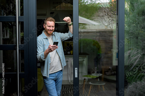 Cheerful happy satisfied smiling businessman or businessperson after a successful meeting. Adult person at the door of it's house overwhelmed with success. © Moon Safari