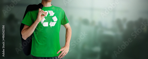 Chest of superhero man with Recycling Symbol logo on t-shirt. Isolated on clean background. Hero business man with recycling logo symbol on green shirt against climate. Environmental concept.