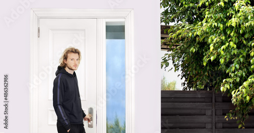 man opening the door of his home. © lado2016