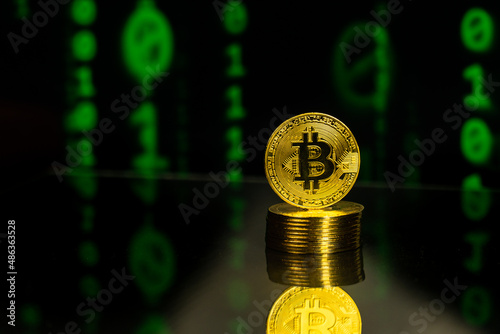 Pile of bitcoins with binary code blockchain background. Crypto currency future of financial trading concept