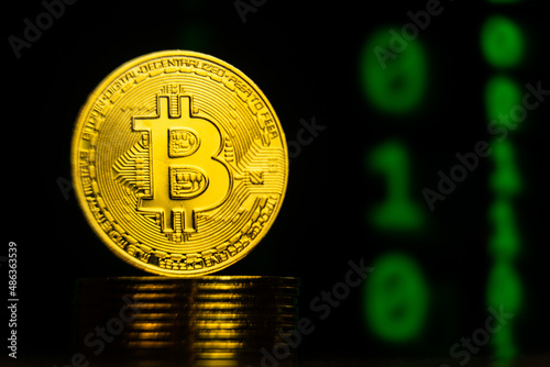 Close up shot of bitcoin with binary code blockchain background. Future digital crypto currency payment system concept