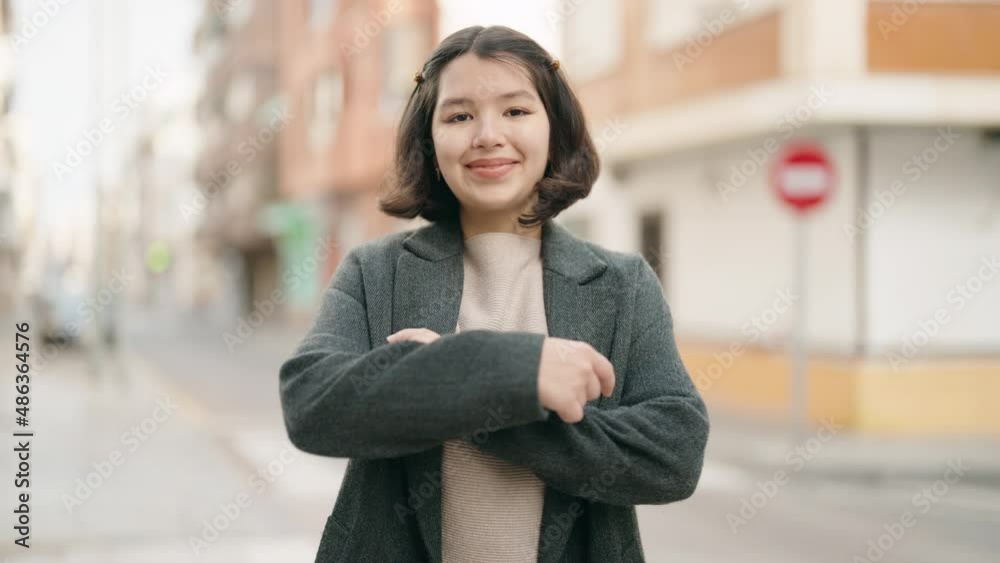 Young hispanic girl smiling confident standing with arms crossed gesture at street Young hispanic girl smiling confident standing with arms crossed gesture at street