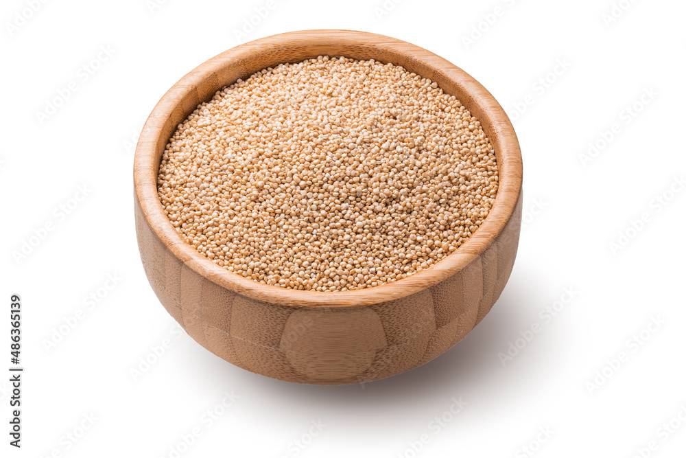 Quinoa seeds in wooden bowl isolated on white background. Organic superfood Quinoa seeds in wooden bowl isolated on white background. Organic superfood