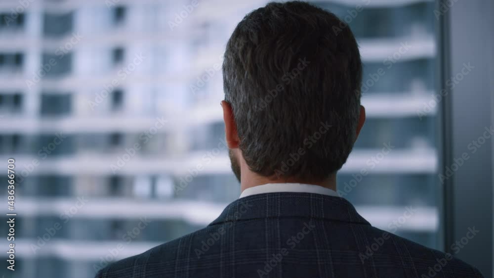 Ceo man looking camera in window office. Businessman posing in finance workplace Ceo man looking camera in window office. Businessman posing in finance workplace
