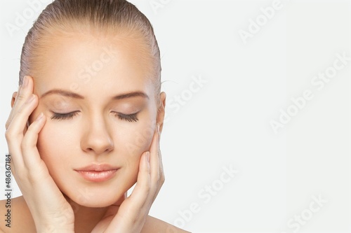 Spa and cosmetology. Young woman smiling happy, holding hands on face