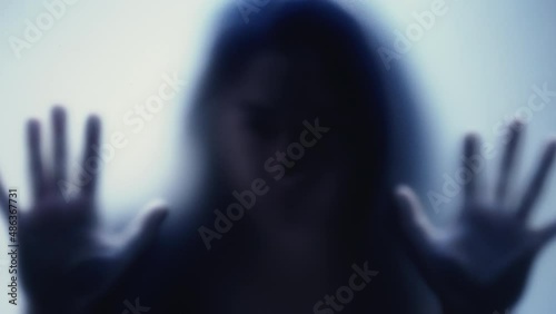 Depressed woman stuck behind glass seeking help and support depression concept photo
