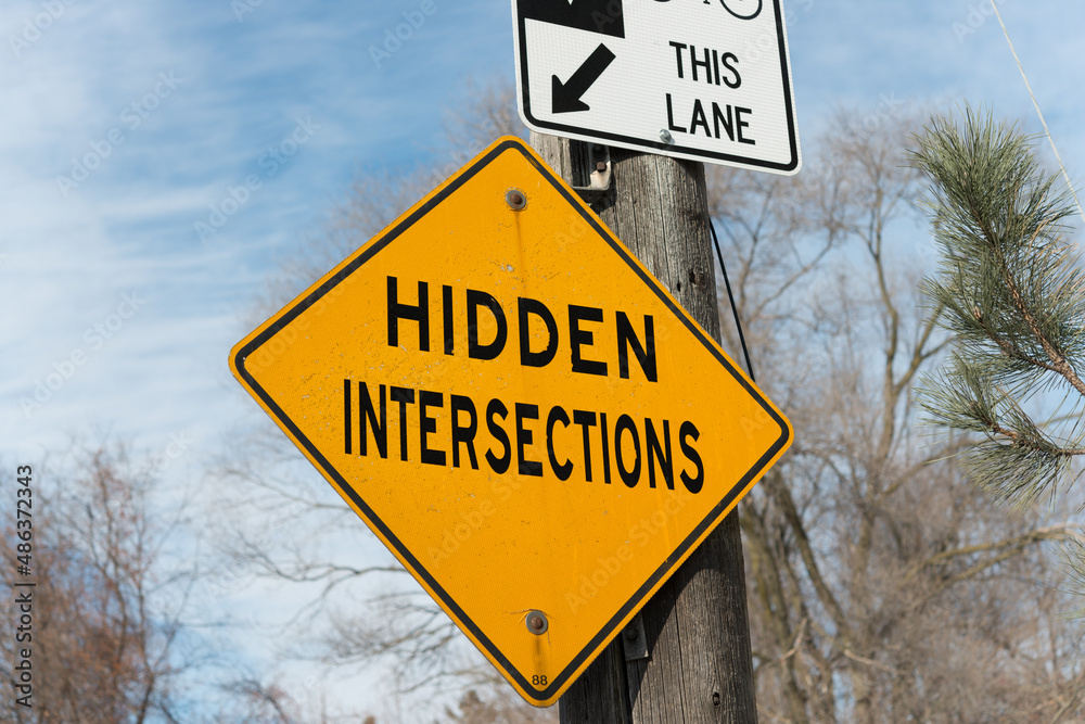 traffic sign with warning of hidden intersections ahead