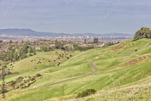 Rolling Green Hills in front of Oakland Skyline During the Day
