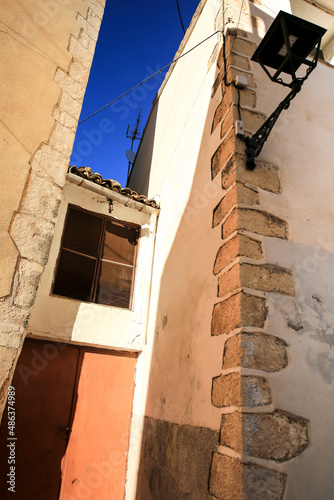 Narrow street and typical facade of Confrides village photo