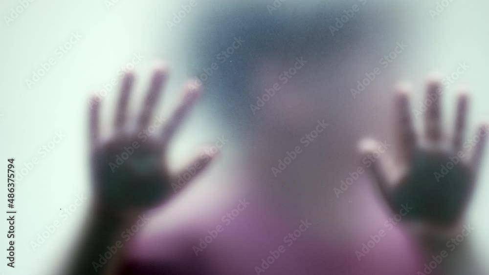 Kid stuck behind matte defocused glass child abuse concept Kid stuck behind matte defocused glass child abuse concept