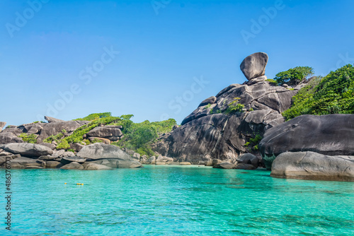 Beautiful landscape people on rock is a symbol of Similan Islands, blue sky and cloud over the sea during summer at Mu Ko Similan National Park, Phang Nga province, Thailand photo