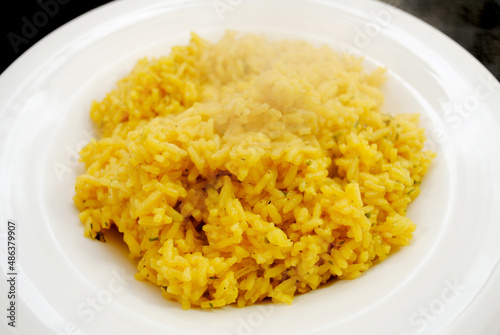 Side Dish of Steaming Herb and Yellow Rice	