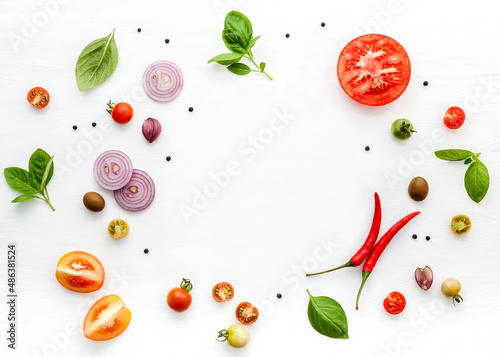 The ingredients for homemade pizza on white wooden background.