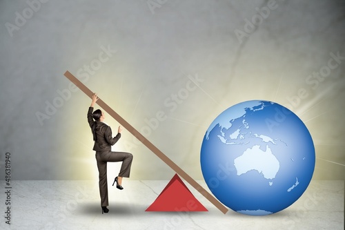 Businessman lifting the earth globe in challenge concept