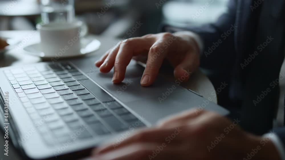 Man hands working computer online using touchpad browsing business news in cafe. Man hands working computer online using touchpad browsing business news in cafe.