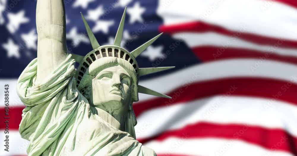 the statue of liberty with the blurry american flag waving in the background