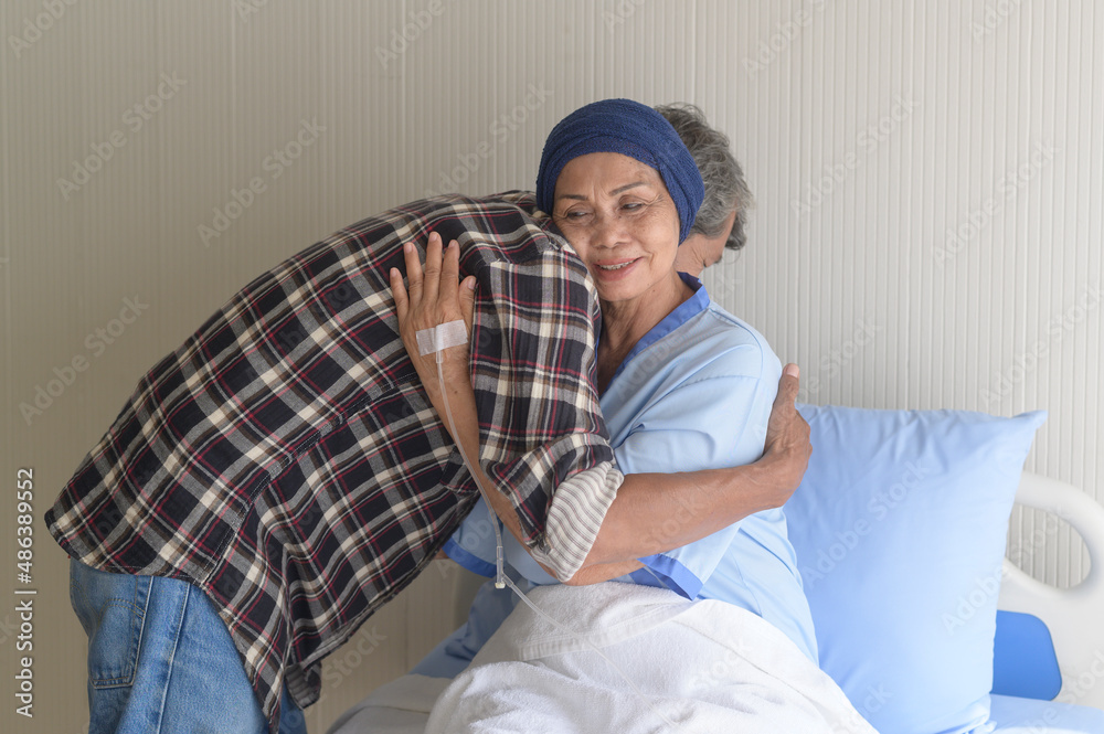 Senior man visiting cancer patient woman wearing head scarf at hospital, health care and medical concept Senior man visiting cancer patient woman wearing head scarf at hospital, health care and medical concept