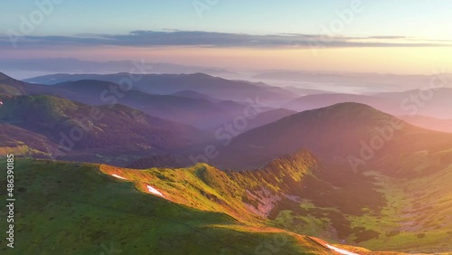 Mountain morning of Ukraine in  Carpathians transparent haze in  valleys sunrise gentle fabulous. Houses of Ukrainian mountaineers  of Verkhovyna. Drone flight video. 