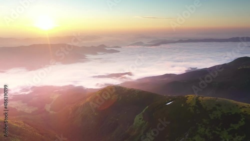 Mountain morning of Ukraine in  Carpathians transparent haze in  valleys sunrise gentle fabulous. Houses of Ukrainian mountaineers  of Verkhovyna. Drone flight video. 