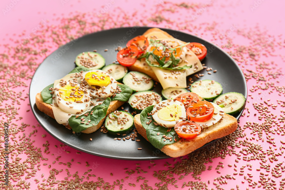 Plate with tasty toasts and flax seeds on color background Plate with tasty toasts and flax seeds on color background