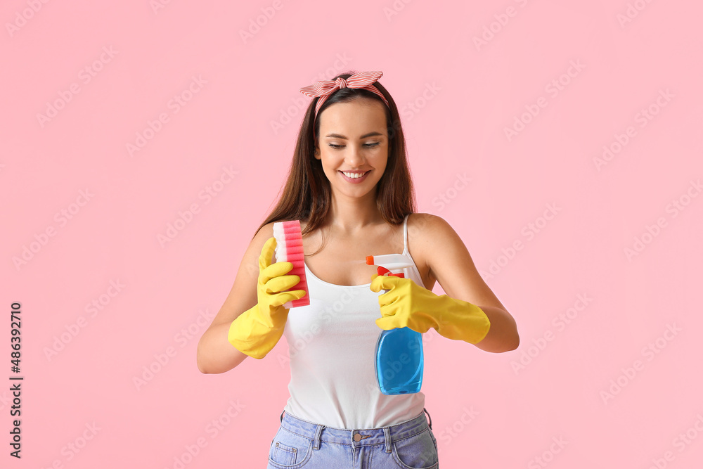 Young woman with sponge and detergent on color background Young woman with sponge and detergent on color background