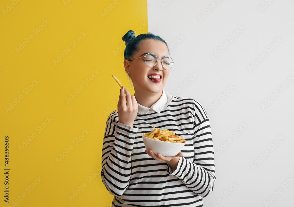 Funny young woman with bowl of french fries on color background Funny young woman with bowl of french fries on color background