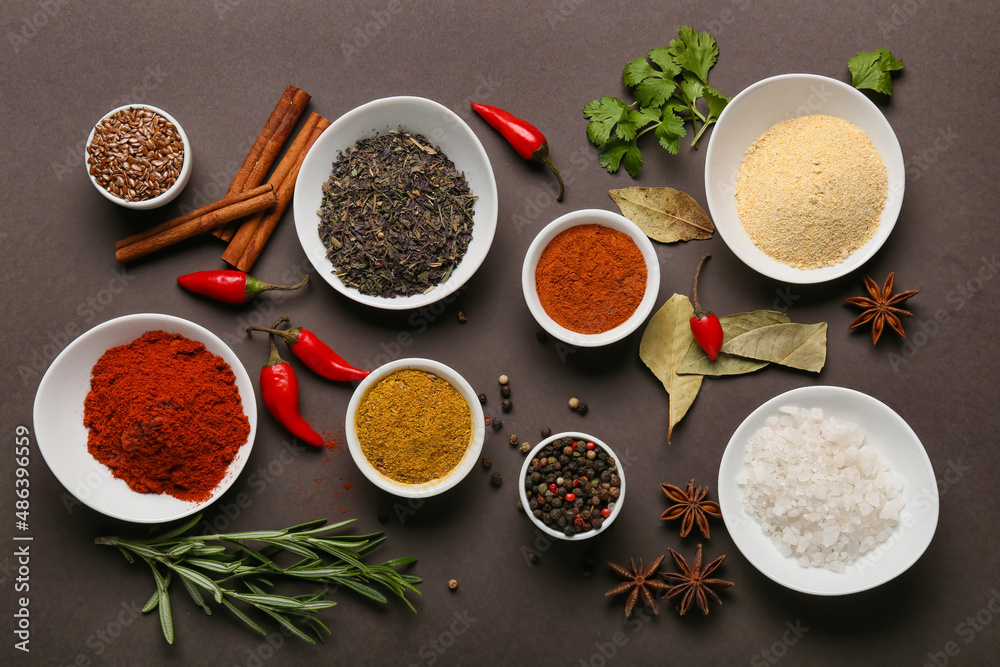 Composition with aromatic spices and herbs on dark background Composition with aromatic spices and herbs on dark background