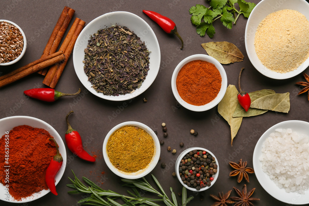 Composition with aromatic spices and herbs on dark background Composition with aromatic spices and herbs on dark background