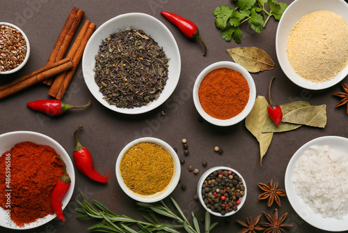 Fototapeta Naklejka Na Ścianę i Meble -  Composition with aromatic spices and herbs on dark background