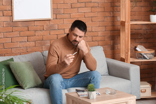 Thoughtful man with cigaret...