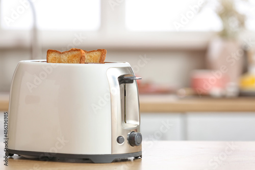 White toaster with bread slices on counter in modern kitchen