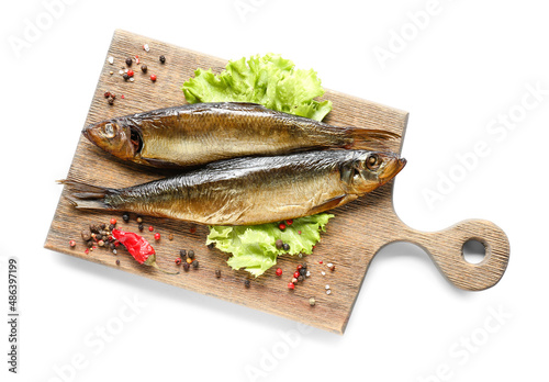 Obraz na płótnie Wooden board with smoked herring fishes on white background