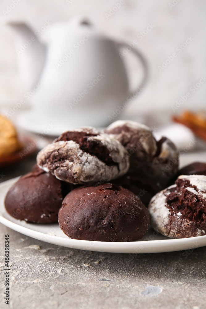 Plate of chocolate brownie cookies on grey background