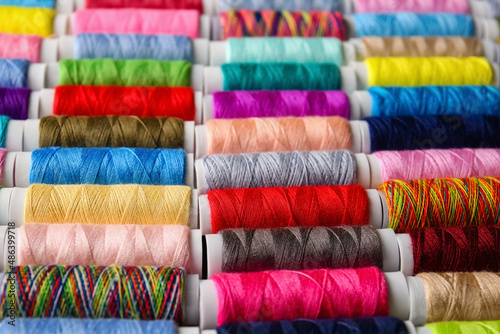 Closeup view of spools with colorful sewing threads