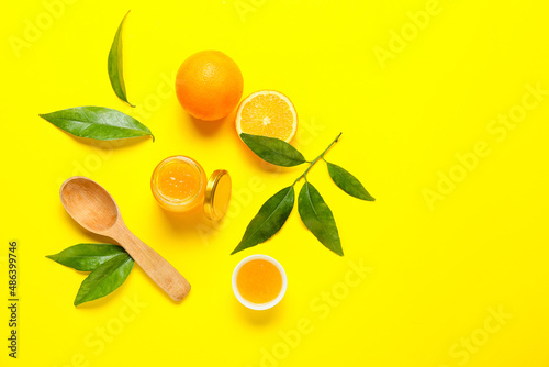 Composition with tasty orange jam on yellow background