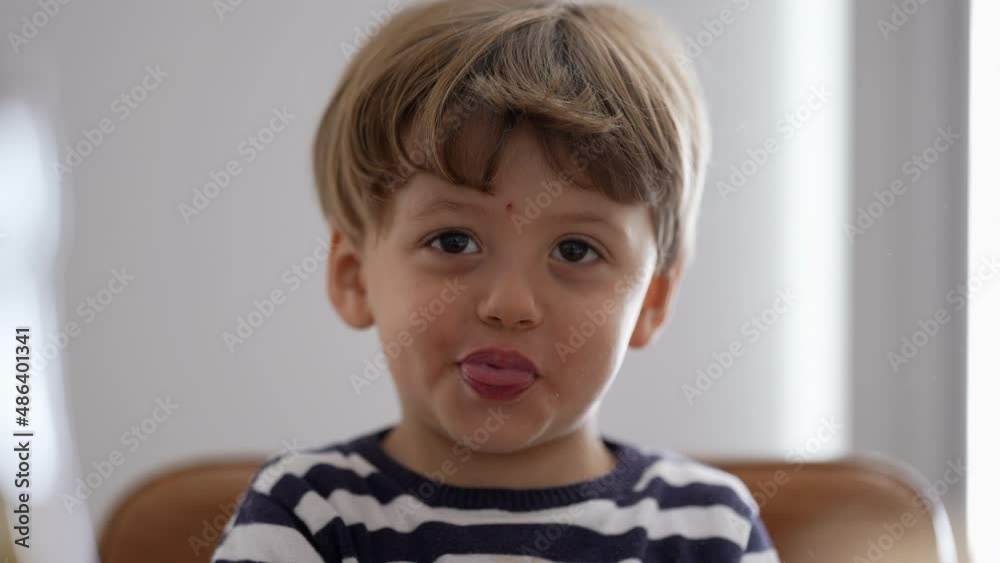 One little boy spitting misbehaving sticking tongue out One little boy spitting misbehaving sticking tongue out