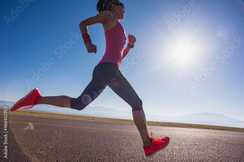 Healthy lifestyle young fitness woman runner running on sunrise road