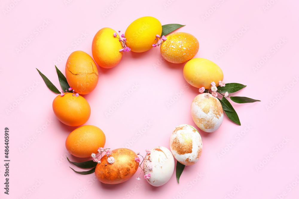 Frame made of beautiful Easter eggs on pink background