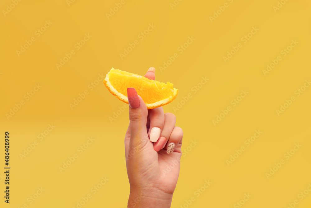 Women's hand shows one piece of orange