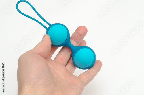 vaginal balls in hand. Female sex toys. on white background.