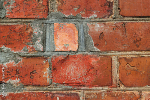 close up of old red brick wall with repaired part